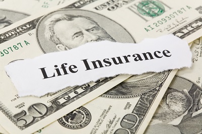 life insurance sign on stack of money